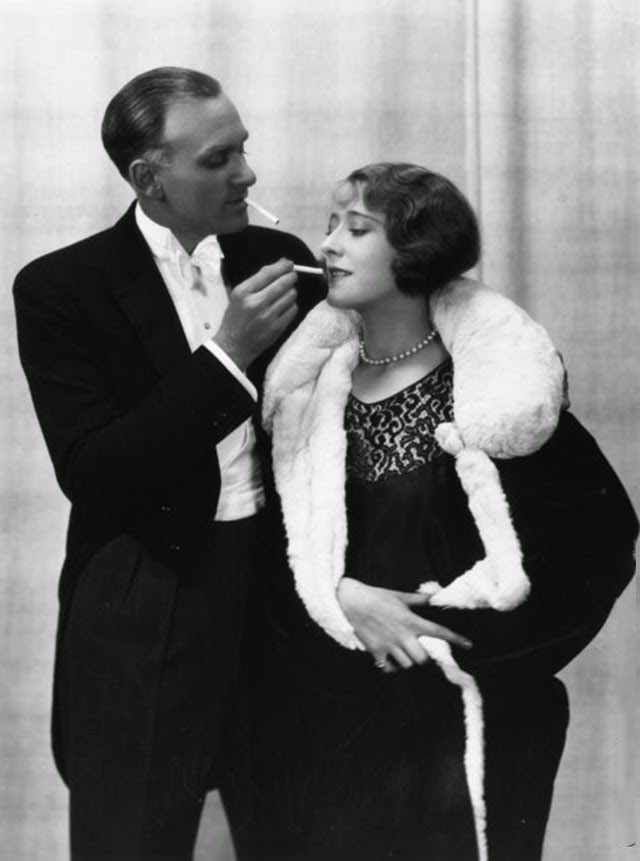 A gentleman offering his partner a cigarette, 1928.