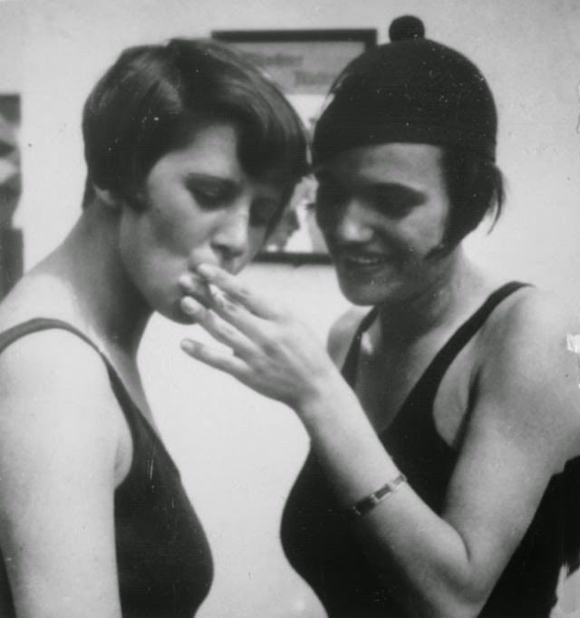 Two girls sharing a cigarette after a swim, 1925.