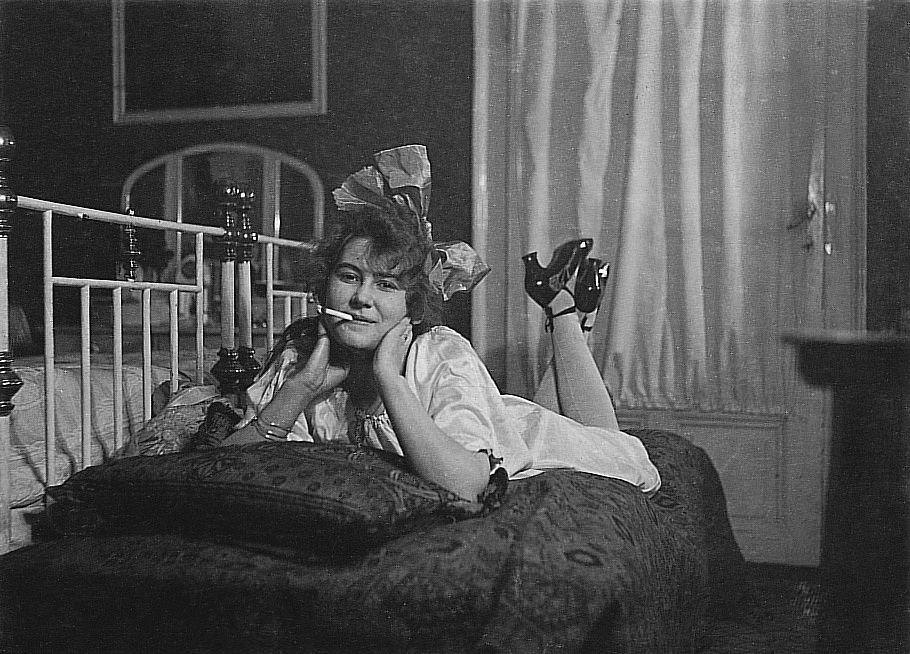 Woman with Cigarette Poses on a Sofa, 1925: Captivating and Timeless