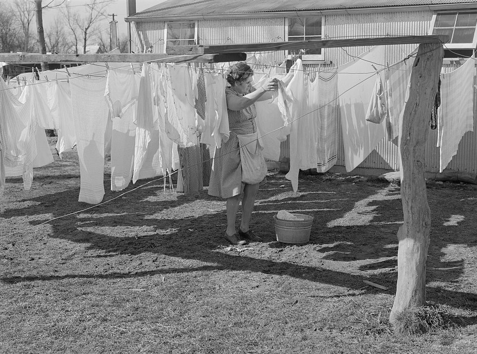 Wife of defense worker hanging out wash in trailer camp on Mount Vernon Highway near Alexandria, Virginia, 1941