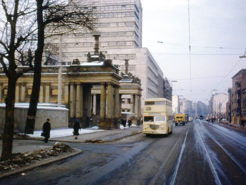 Line 48 bus passing entrance to Kleist Park and the Allied Control Authority Building. New BVG headquarters are in the high-rise office building in rear, Berlin, 1954