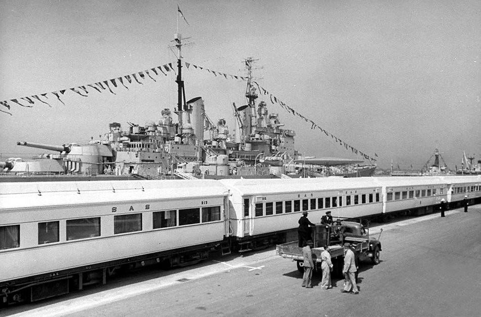 H M S Vanguard that brought the Royal's to Cape Town forms a majestic backdrop to the immaculate White train that was used for the tour through the Union of South Africa.