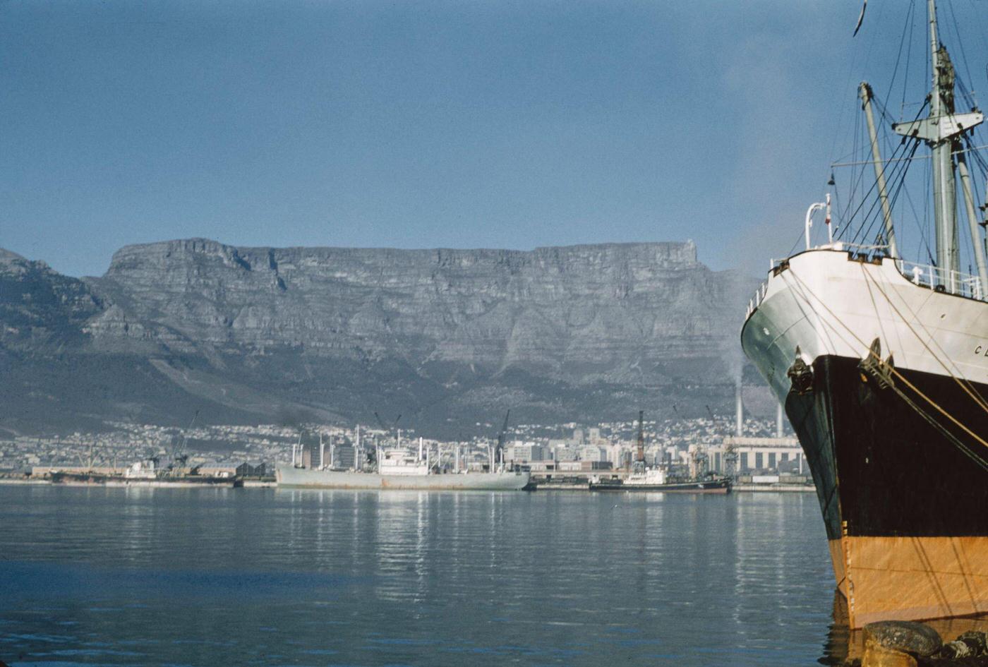 Cargo ships moored in the harbor of the Port of Cape Town below Table Mountain in the city of Cape Town, 1960