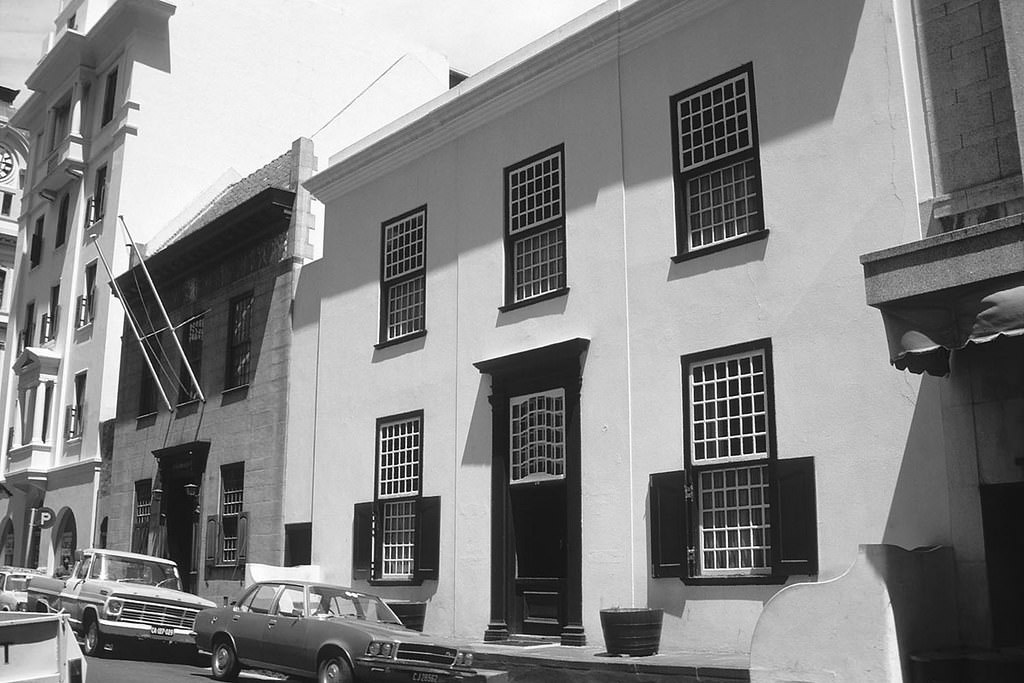 14 Keerom Street and the one with the flagpoles is 16 Keerom Street which used to be the Netherlands Club now both are a restaurant.