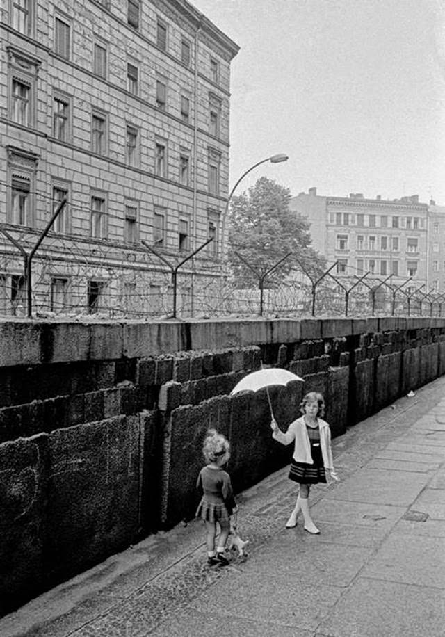 Children playing on the western side of the Berlin Wall.