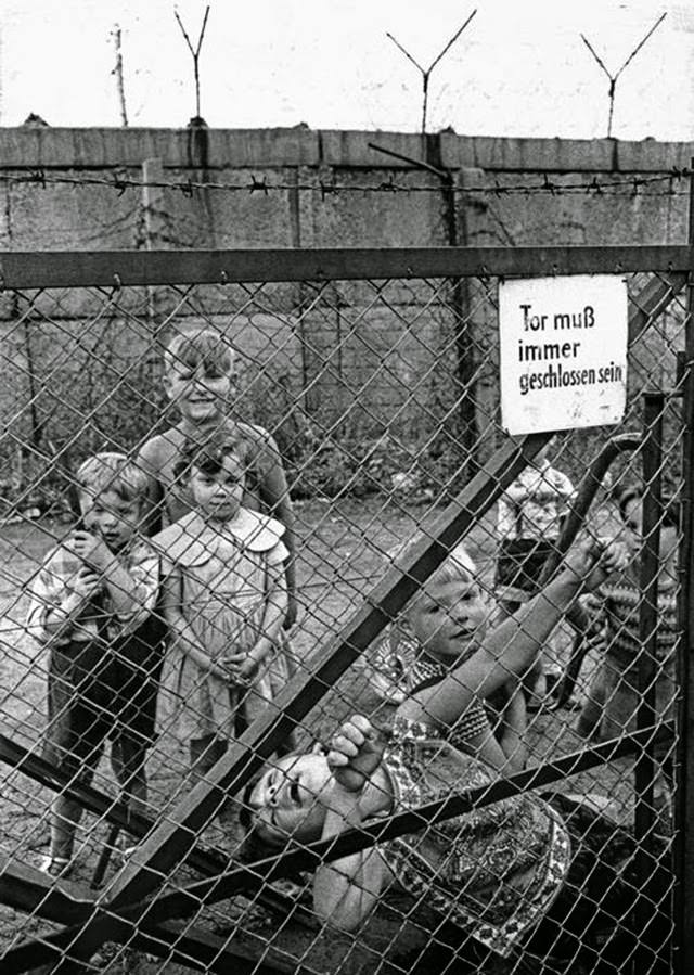 Children playing on the western side of the Berlin Wall.