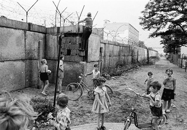 Children playing on the western side of the Berlin Wall.