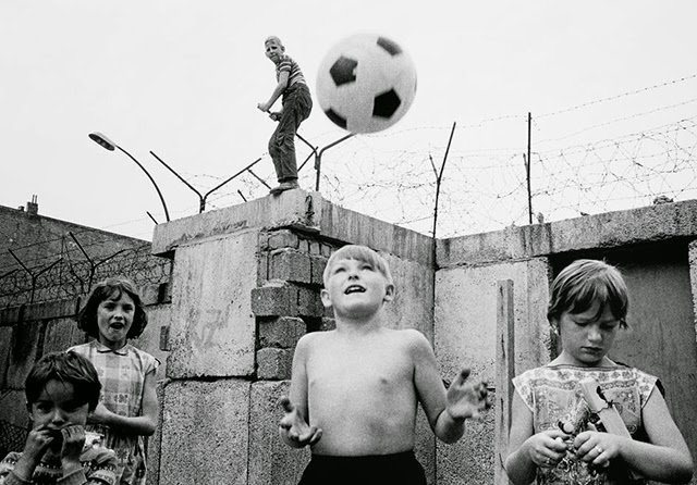 Children playing on the western side of the Berlin Wall.