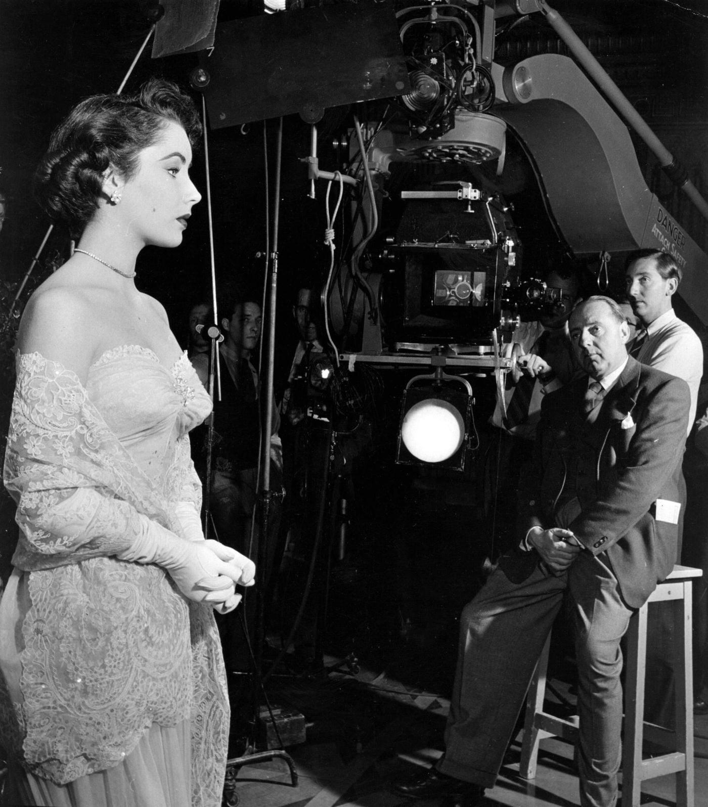 Elizabeth Taylor on the set of the film 'Conspirator' with director Victor Saville.