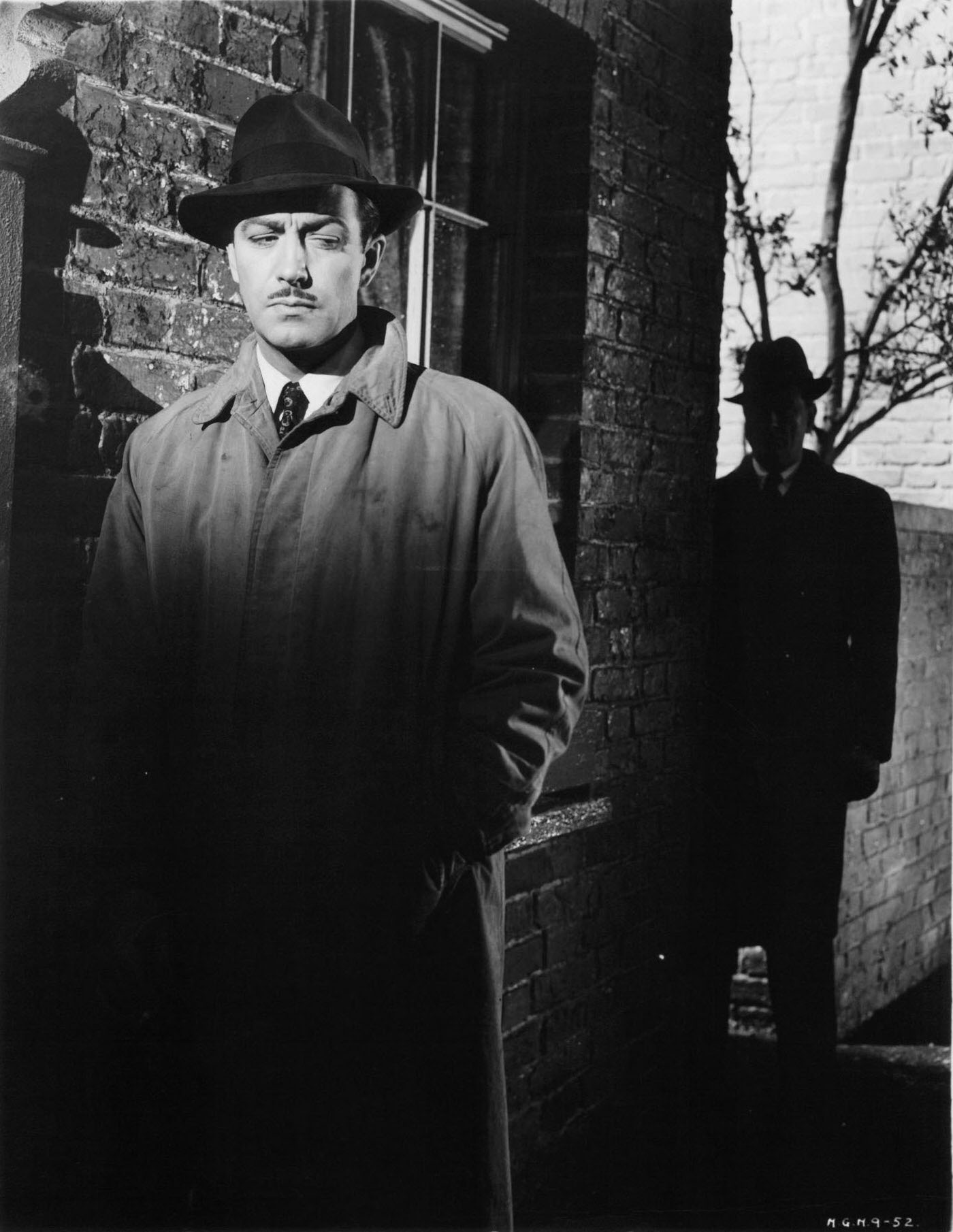 Robert Taylor being followed by a shadowy figure in a scene from the film 'Conspirator', 1949.