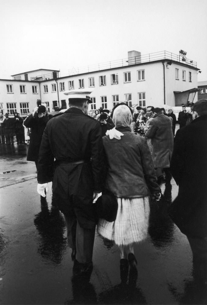 Priscilla Beaulieu is escorted from the tarmac after saying goodbye to Elvis, Germany, March 1960.