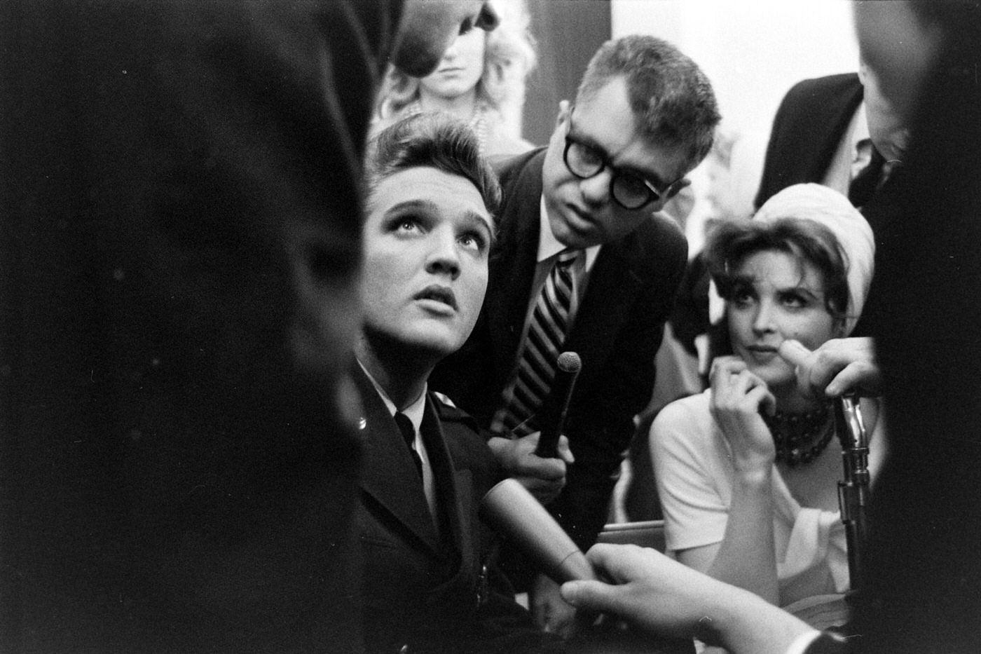 Elvis Presley (and, at right, actress Tina Louise) at Fort Dix, New Jersey, shortly before his discharge from the U.S. Army, March 1960.