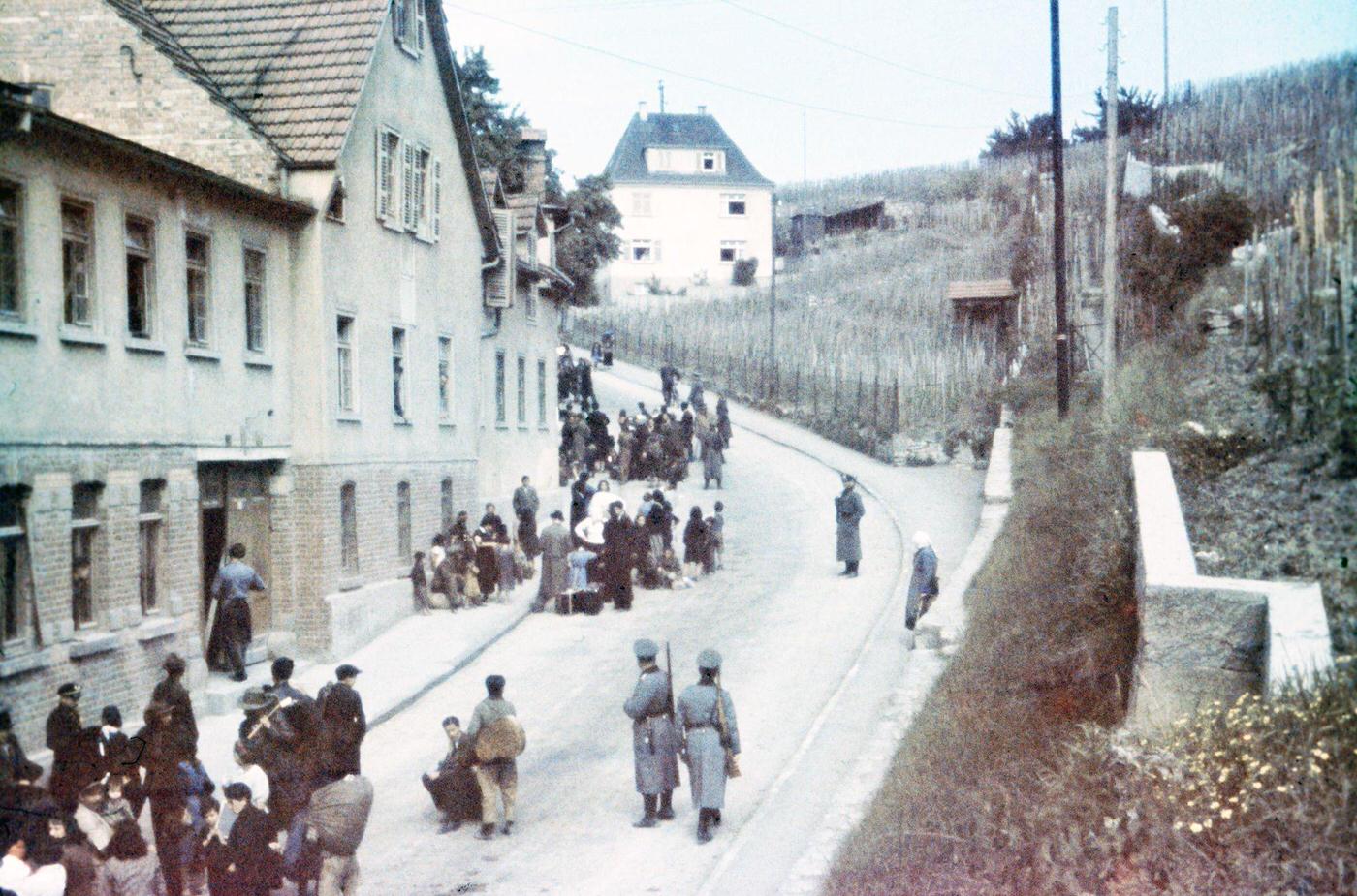 Sinti under police surveillance on Königstraße in Asperg before being locked up at Hohenasperg prison prior to deportation to camps in Poland, May 22, 1940.