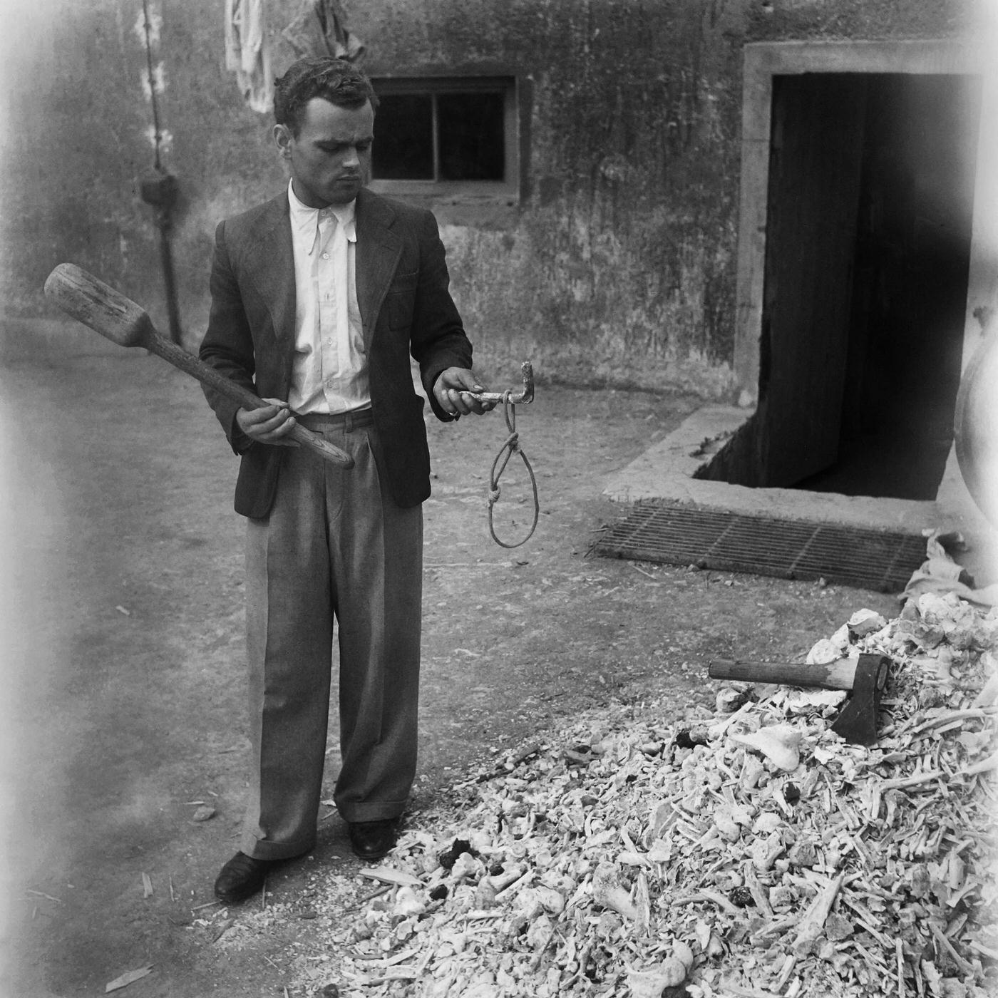A man shows a noose used for hanging in Buchenwald concentration camp in April 1945.