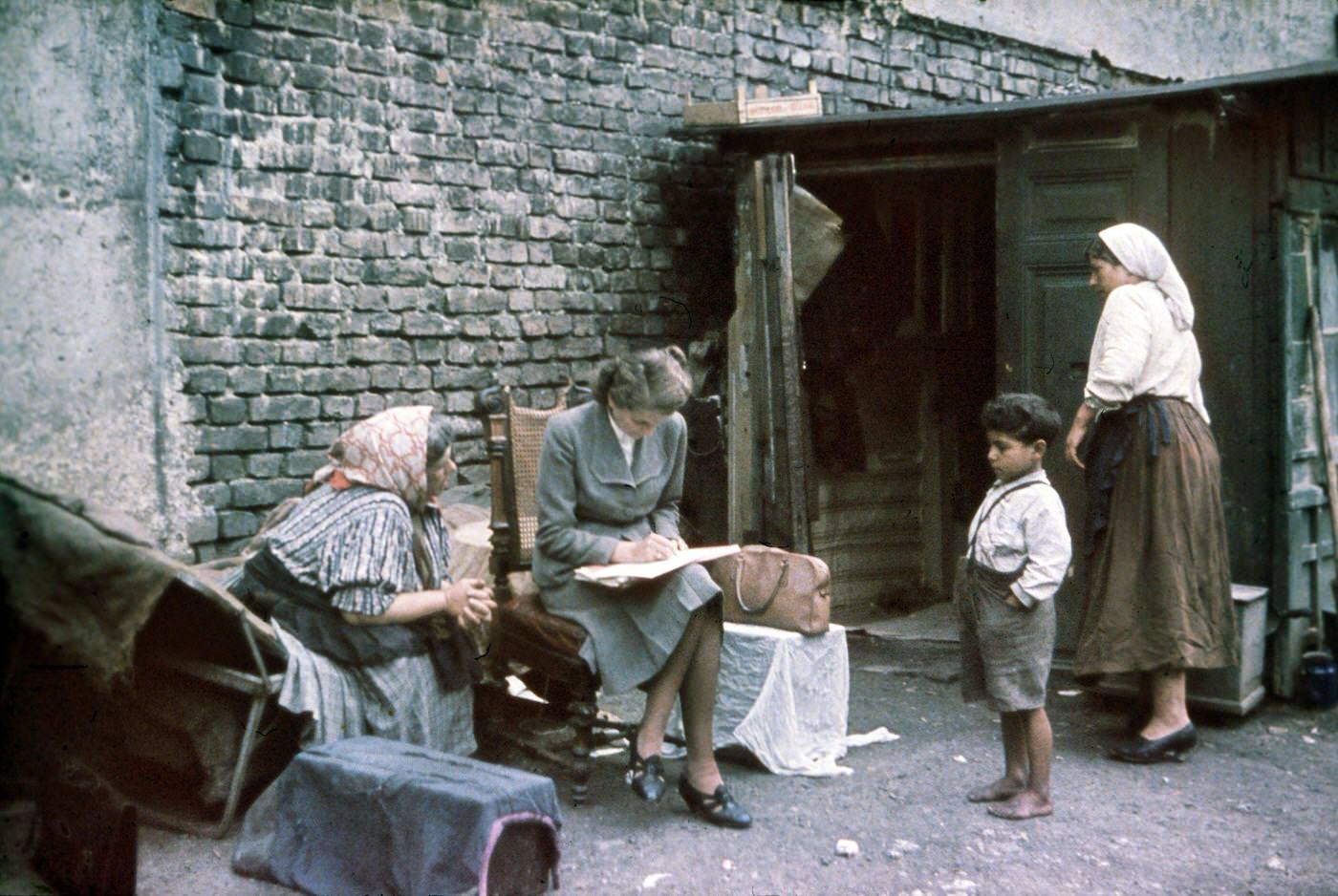 Eva Justin of the Racial Hygiene Research Center conducting an interview with an old woman during the Gypsy (Sinti and Roma) deportation in 1938.