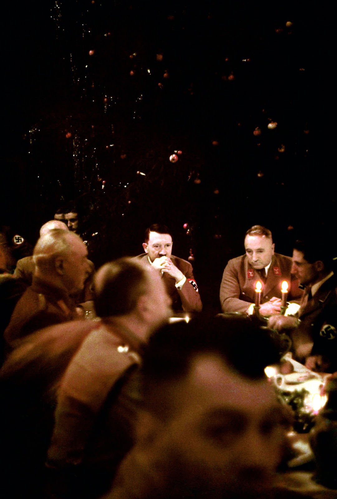 Hitler (center left) appears ill at ease at the Christmas party