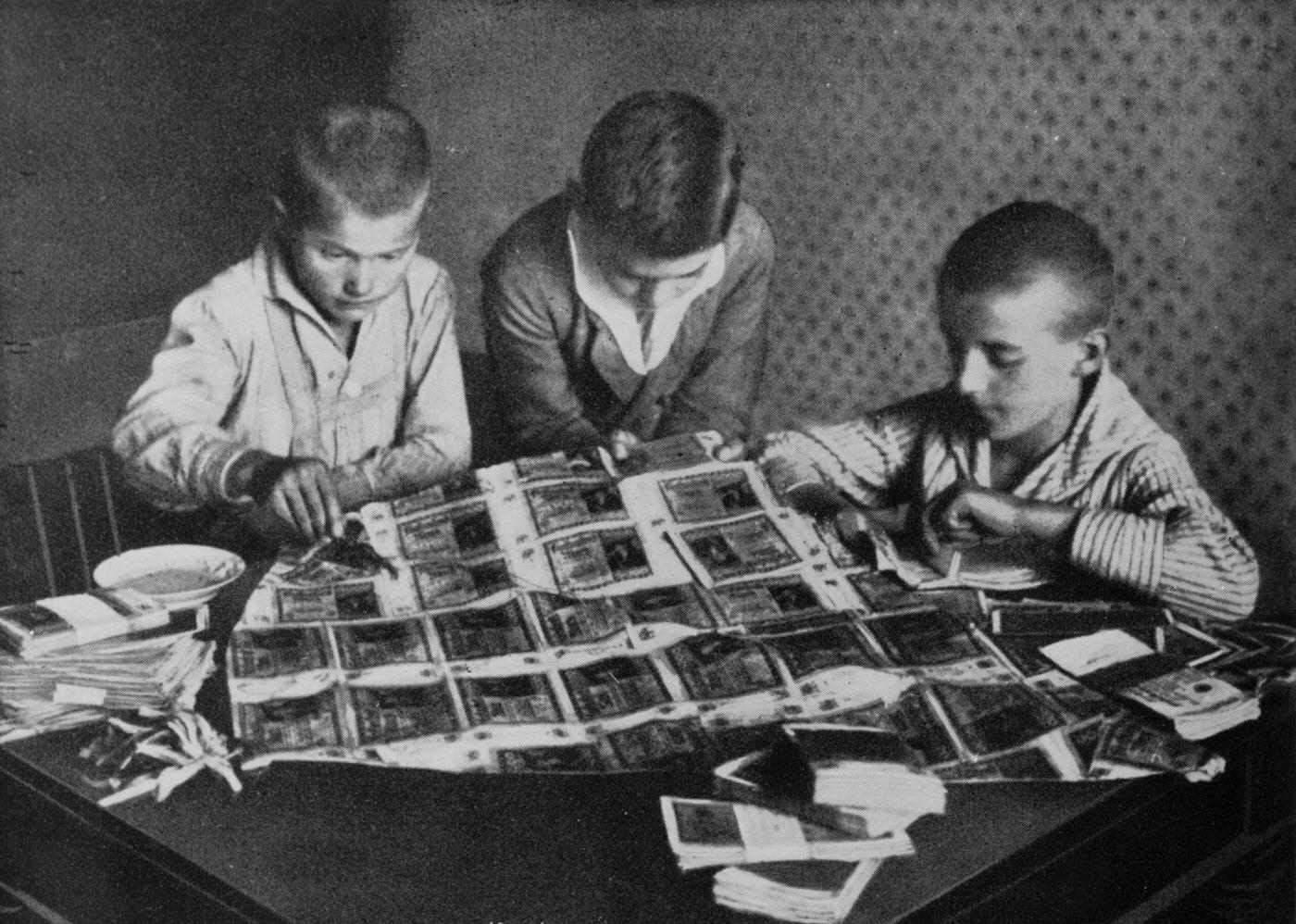 Children play with worthless money during post-war hyperinflation in Germany, circa 1923.