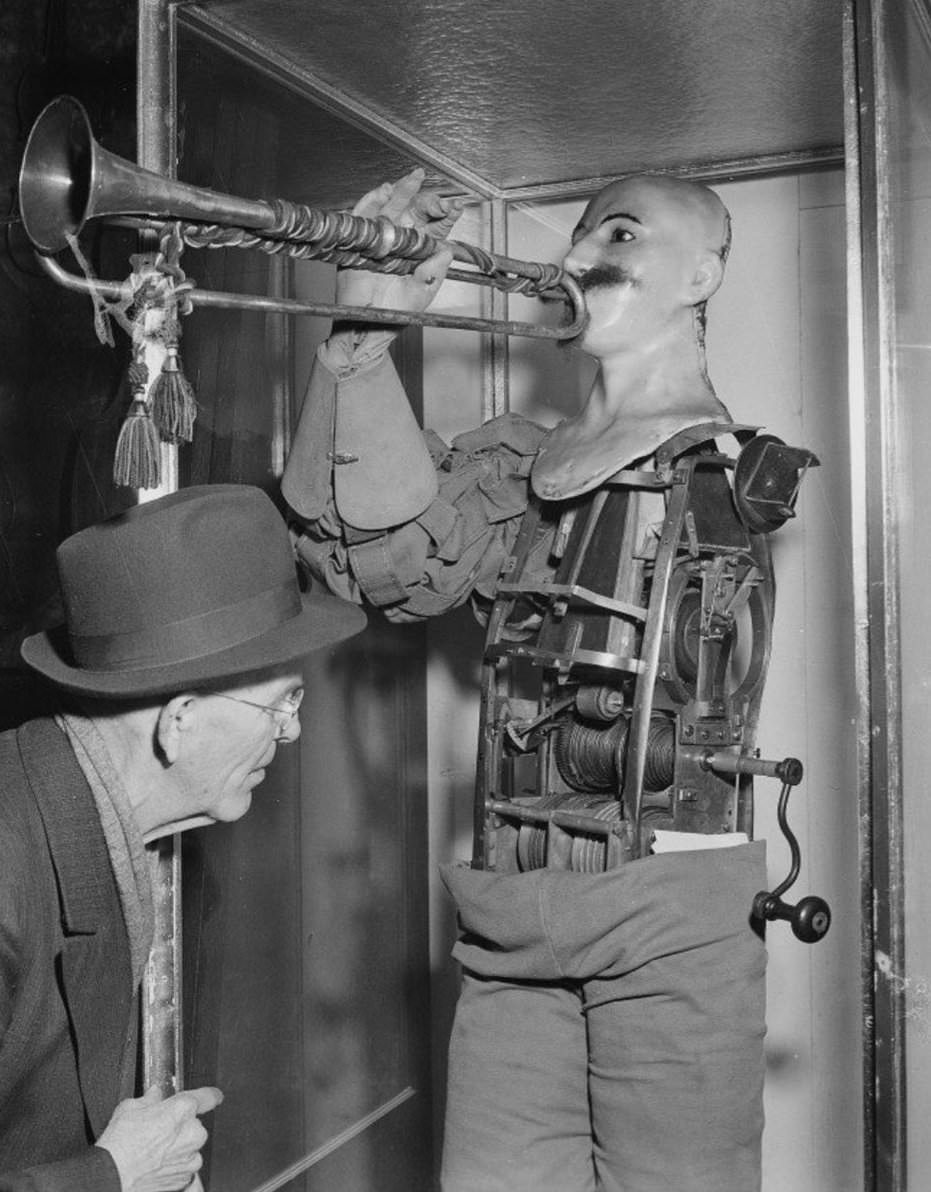 In this April 30, 1950 file photo, a man inspects what is said to be the first robot in history on display in the Deutsches Museum in Munich.