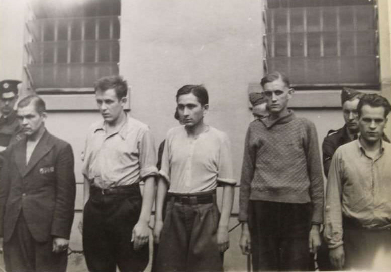 A group of unidentified prisoners are lined up against a wall during their detainment at Celle Prison, in Germany.