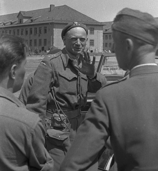 This officer appears to wink at the camera after the camp's liberation by American troops in 1945. His uniform suggests he was a member of the Polish military exiled to Great Britain. After Poland's fall to Nazi Germany in 1939, the wartime government recognized by the Allies maintained its seat abroad, from 1940 onwards in London.