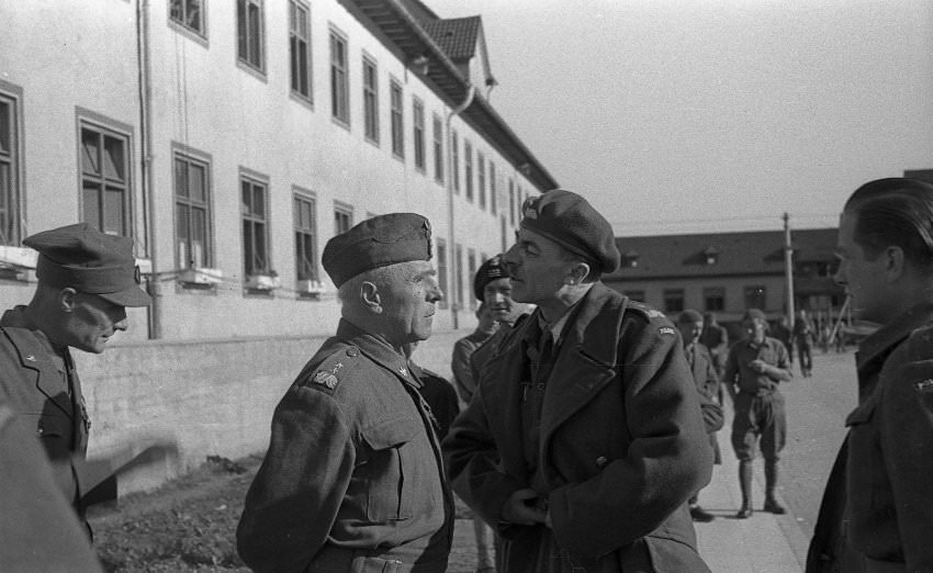 Two Polish officers at the camp converse. The photo begs the question of who the photographer was, since he was allowed to come so close to the men.