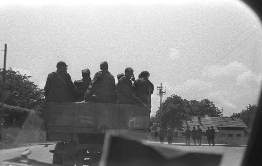Soldiers sit on a truck with the inscription "PW Camp Murnau." It was this photo that gave Olivier Rempfer and his father, Aliain, the first clue as to where the photos where taken.