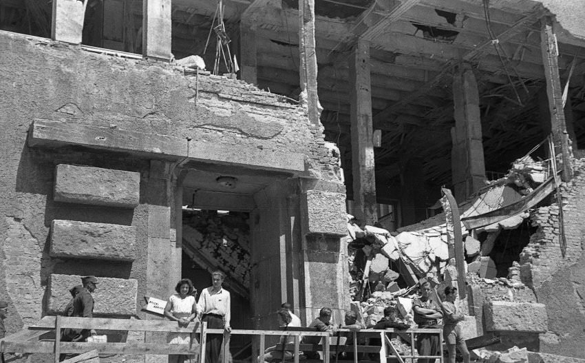 Another picture from Munich shows a young couple posing before a bombed-out building.