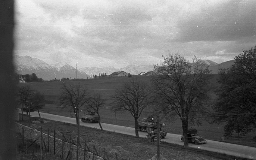 In the afternoon of April 29, 1945, American soldiers approached Murnau from the north as a vehicle with SS officers drives past.