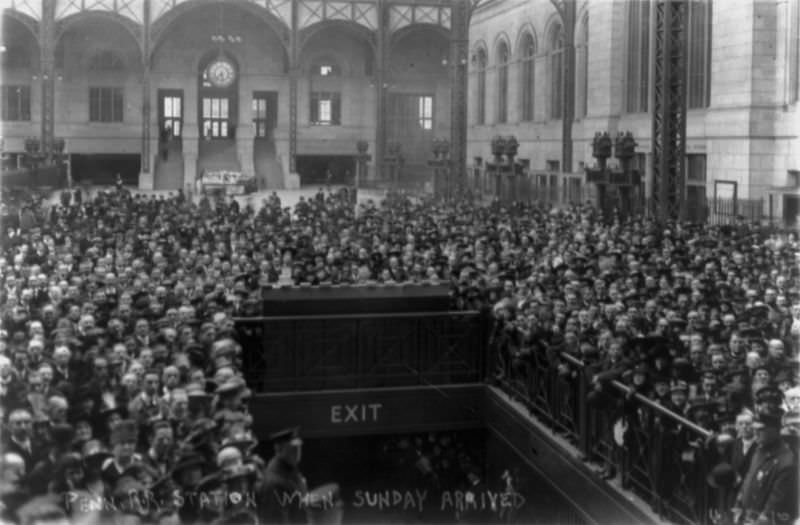 Crowd gathered around exit at Pennsylvania Station awaiting the arrival of Billy Sunday, 1917.