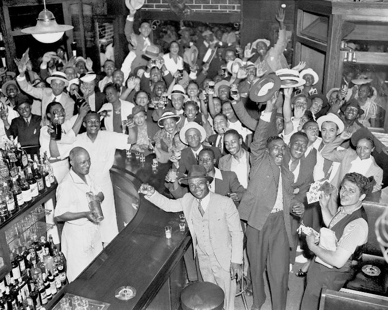 People in Harlem celebrate after Joe Louis' win over Primo Carnera, 1935.
