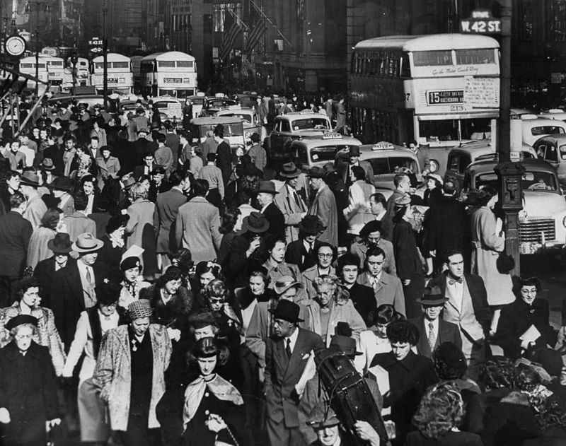 Typical crowded urban scene in Midtown Manhattan looking north on 5th Ave from 31st Street, 1948.