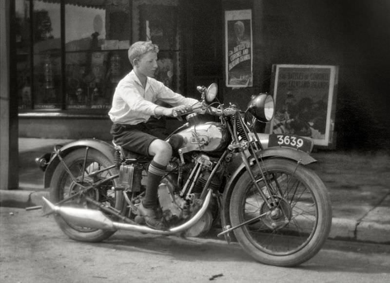 A young lad tries a BSA motorcycle for size in Melbourne, Victoria, 1927
