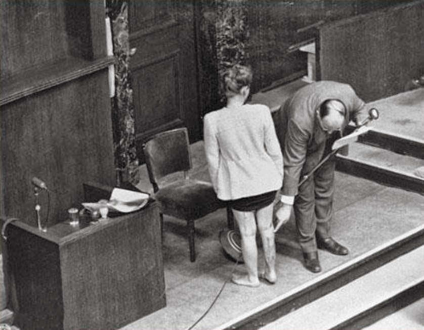 Alexander points at scars on the leg of Polish survivor Jadwiga Dzido, who endured sulfanilamide experiments at Ravensbruck concentration camp.