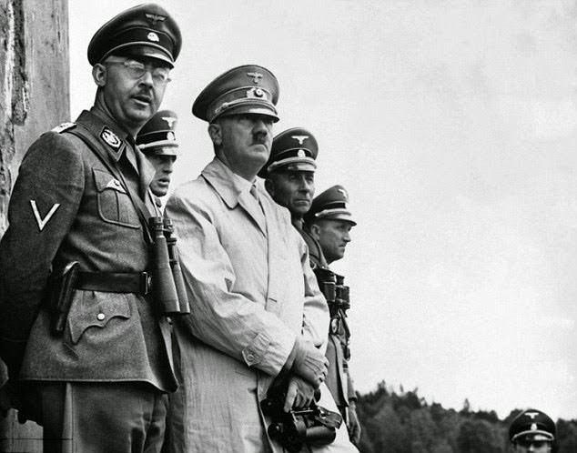Gestapo head Heinrich Himmler (left) oversaw the running of the concentration camp system during the Holocaust and made frequent stops at Ravensbruck. He is pictured with Hitler at a military parade above.