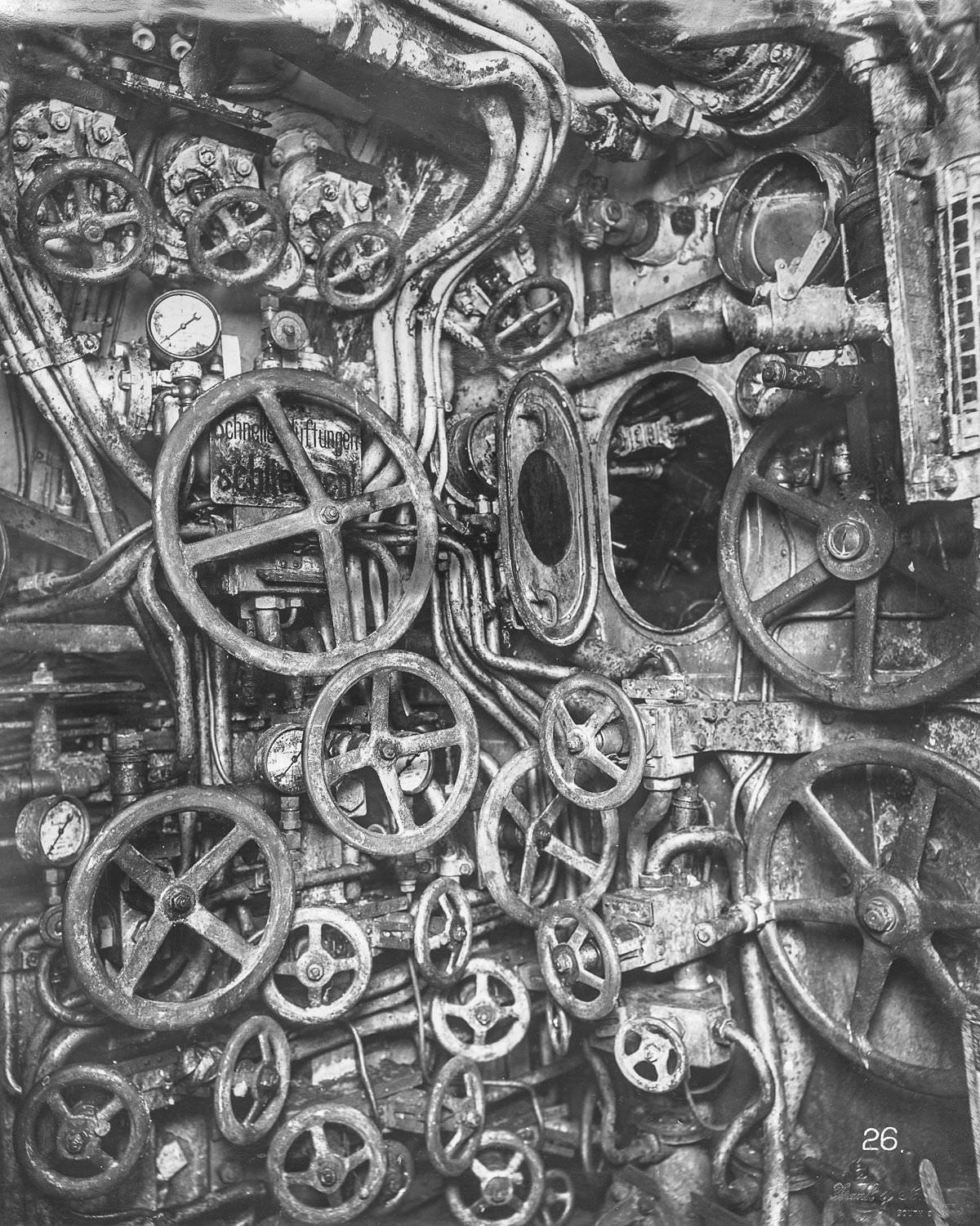 Control room looking aft, starboard side. The manhole to the periscope well and various valve wheels for flooding and blowing are visible.