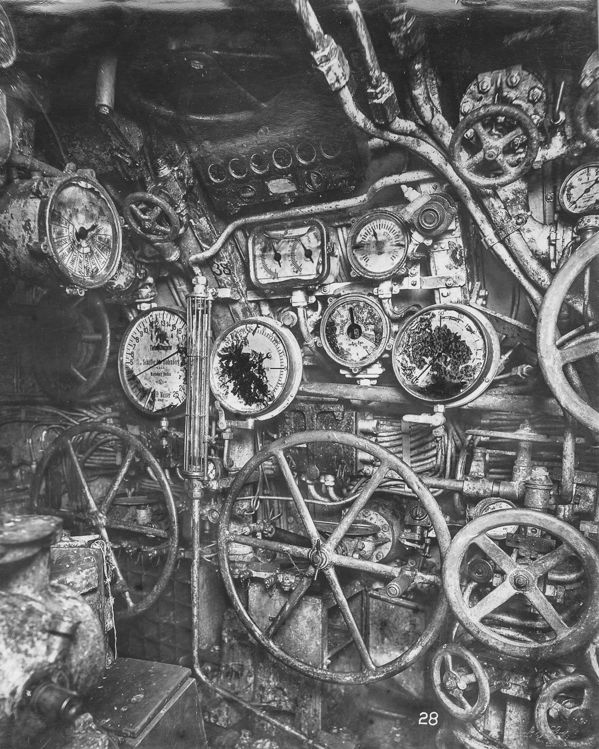 Control room looking forward. The depth gauge, engine telegraphs, wheels for flooding and blowing, and hydroplane controls are visible.