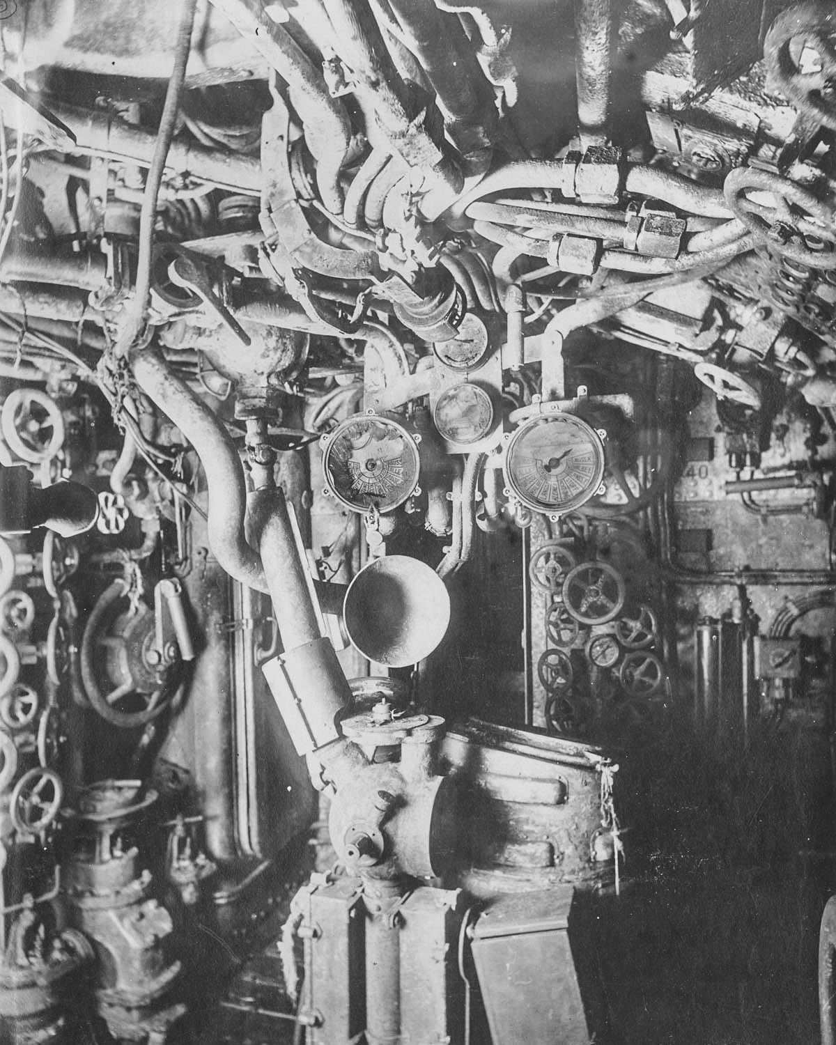 Control room. The gyro compass, steering control shaft, engine telegraphs and voice pipes are visible.