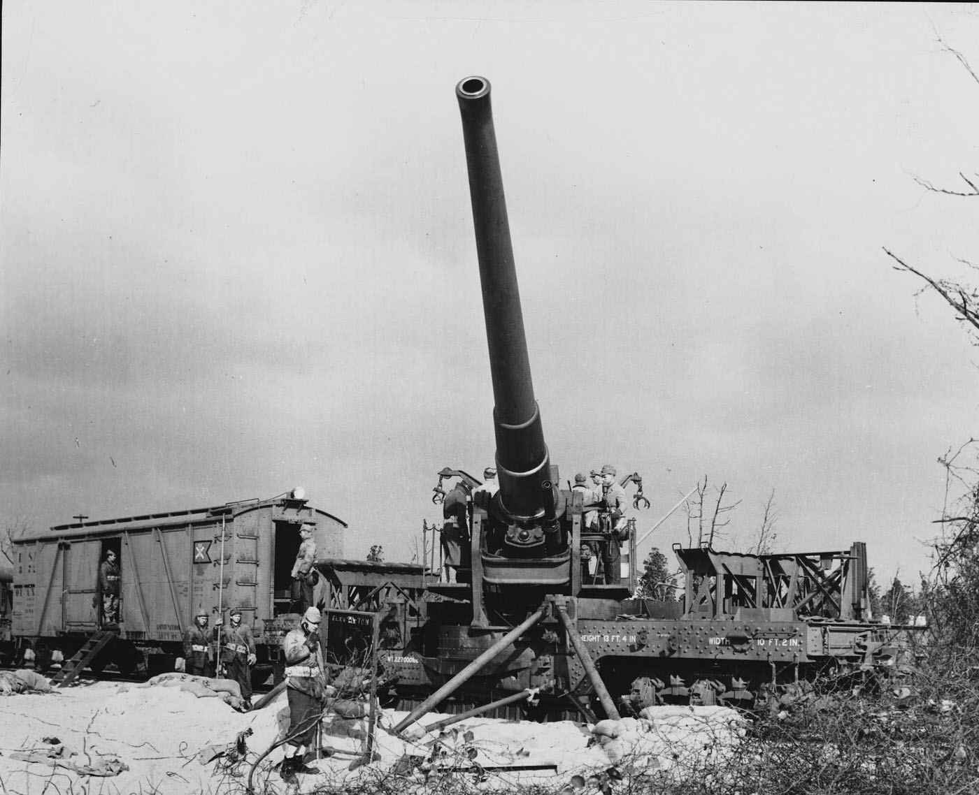 Long-range gun mounted on a railway carriage pointing out to sea.