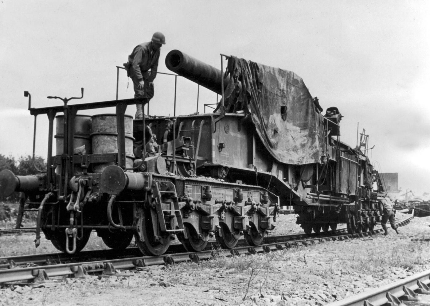 American soldiers examining an abandoned German giant gun on a railway southeast of Torigny-sur-Vire, France, in 1944.