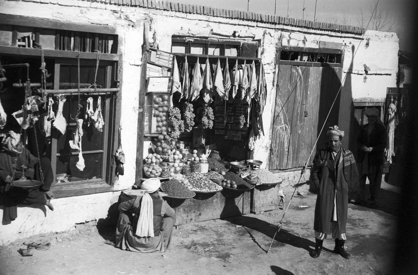 People walking past stalls on the road to Kabul, 1950s