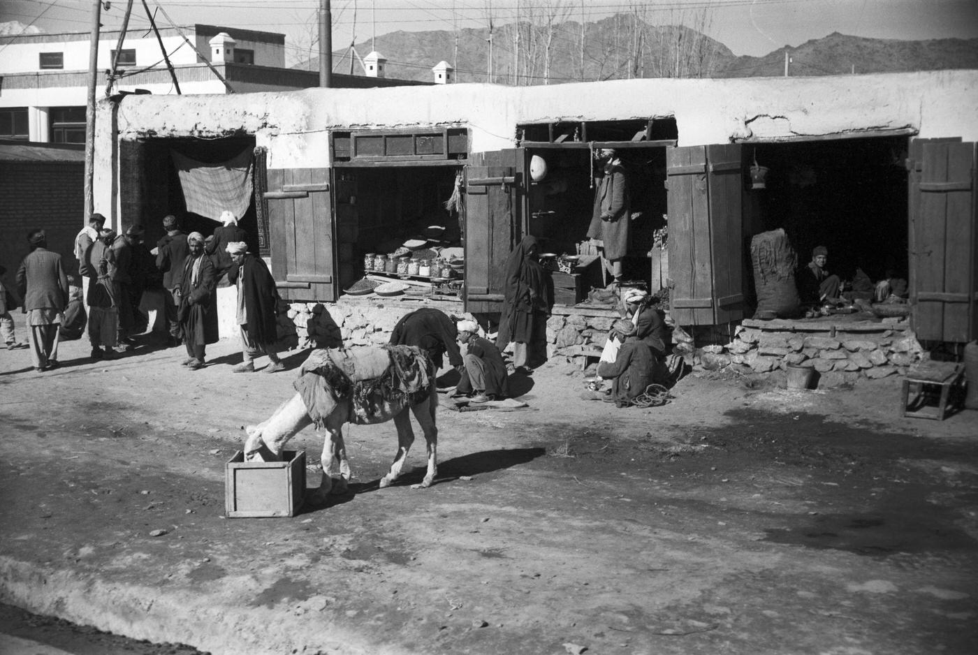 Residents in front of stalls on the road to Kabul.