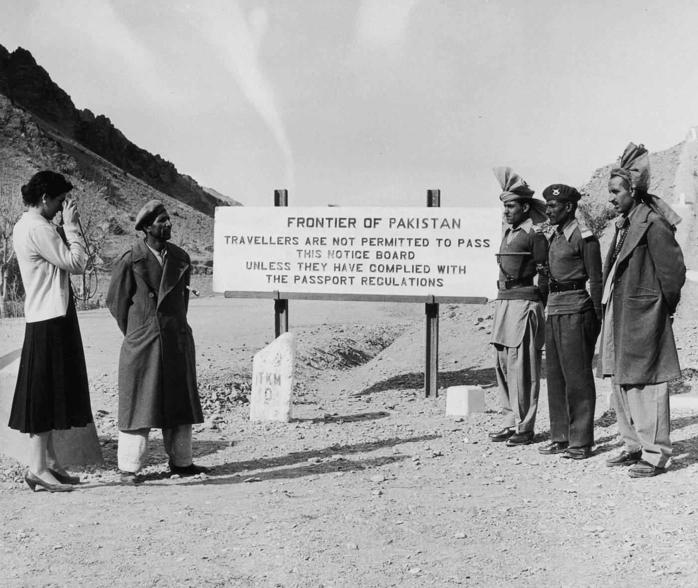 Woman taking a photograph at the Pakistan-Afghanistan border, 1955.