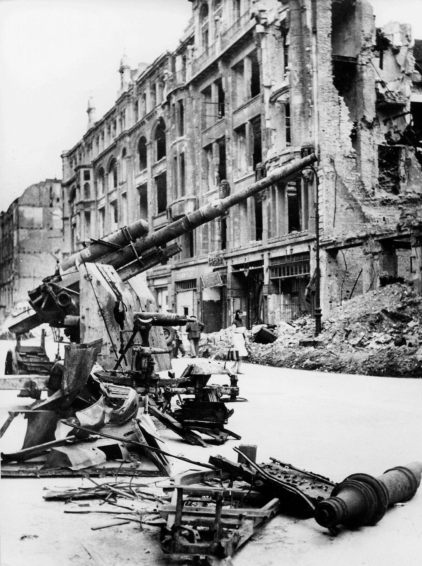 Destroyed street in Berlin with a wrecked anti-aircraft gun, 1945.