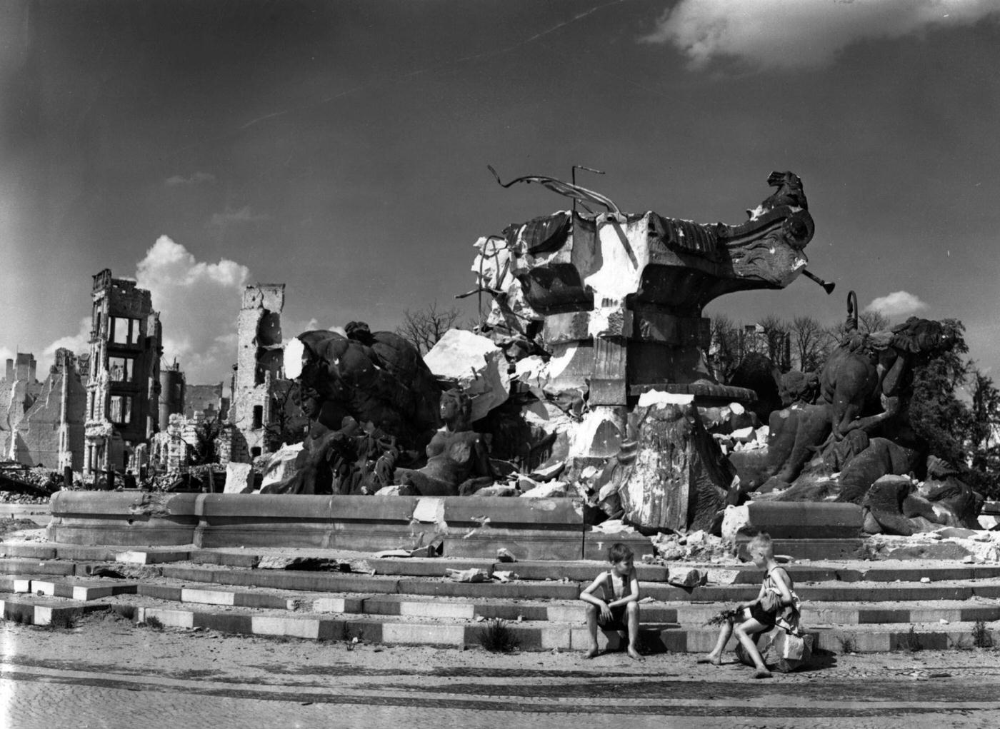 Two boys on the steps of the devastated statue of Hercules in Lutz Platz, Berlin.