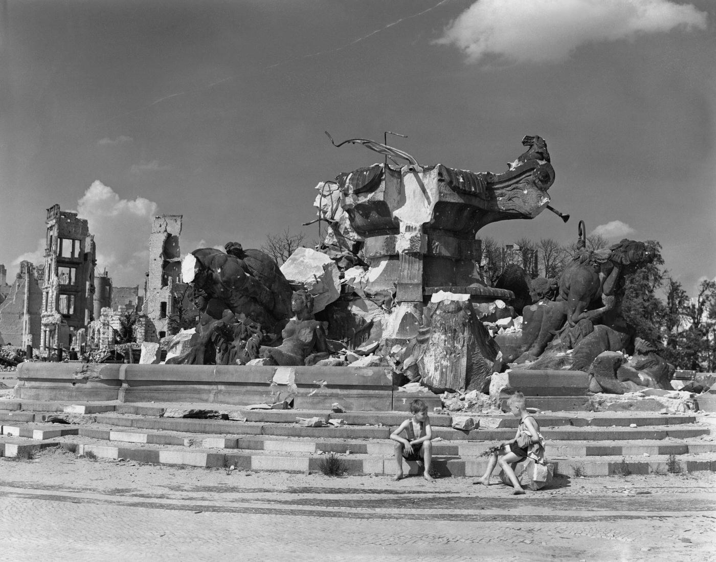 Boys on the steps of the ruins of the Hercules Statue in Rutz Platz, Berlin, 1945.