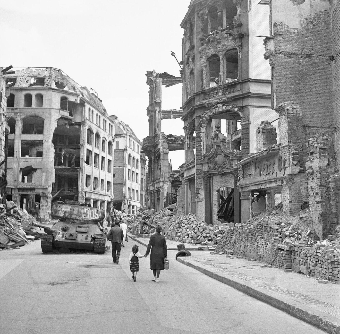 People walking through the city of ruins in Berlin, Germany, circa 1945.
