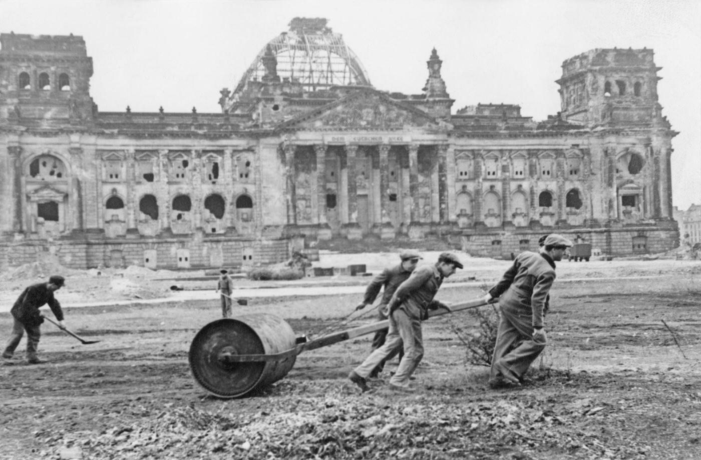 Workers flatten the wasteland in front of the ruined Reichstag in preparation for the 'Day of National Work,' 1947.