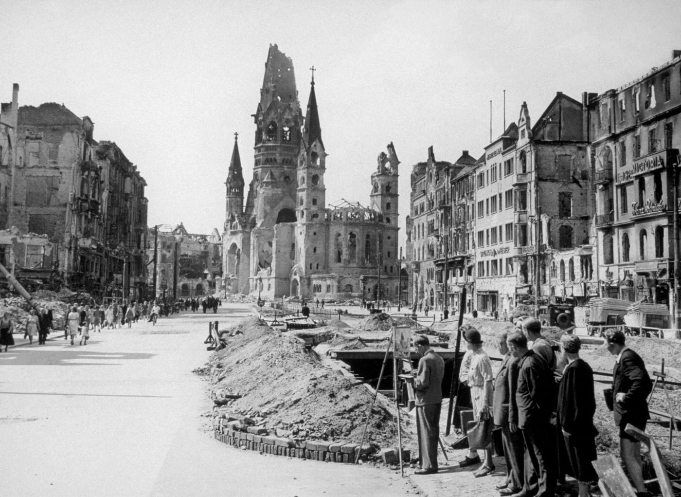 Artist makes a permanent record of a battered section of Berlin with the Kaiser Wilhelm Memorial Church in the background, 1945.