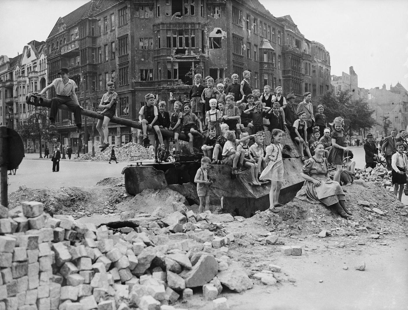 German children playing on a tank in a bomb-damaged part of Berlin, 1945.