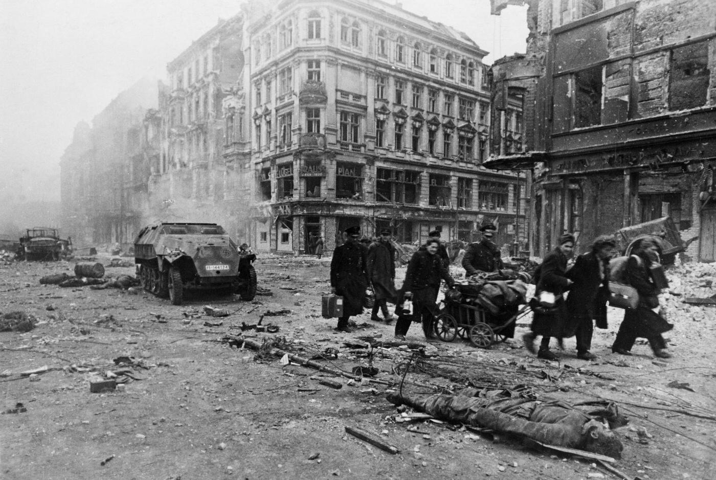 Civilians emerging from cellars and moving to safer areas after the fighting ended in Berlin, Germany, 1945.